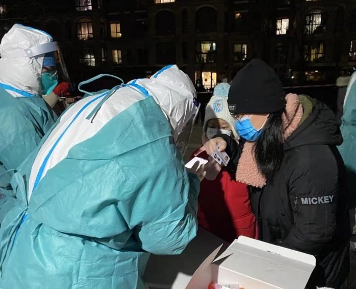 Medical workers take swab samples from residents for COVID-19 tests at a residential compound in Chaoyang District of Beijing, on Wednesday, Feb. 23, 2022. . (Xinhua/Chen Zhonghao/IANS)