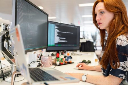 A woman in an office researching federated search on her computer